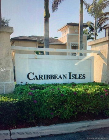 Front view of a building complex entrance sign labeled 'Caribbean Isles'.