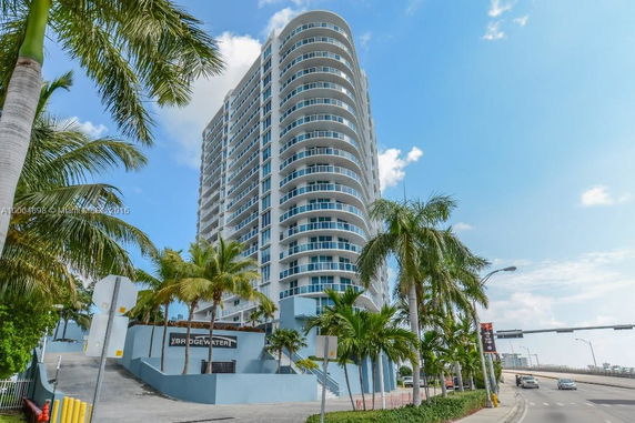Front view of a high-rise residential building with balconies.