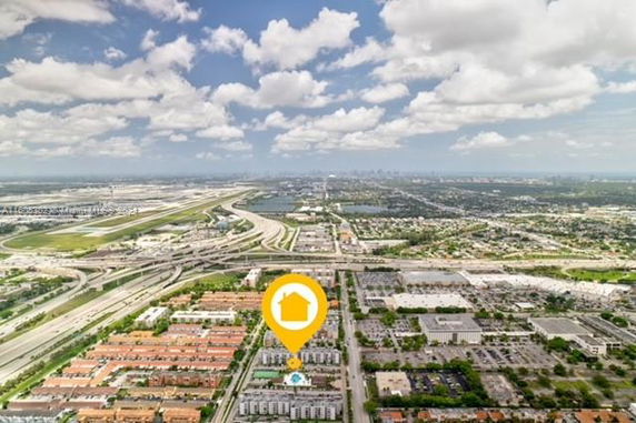 Panoramic view of a city with various buildings, roads, and a highlighted location.