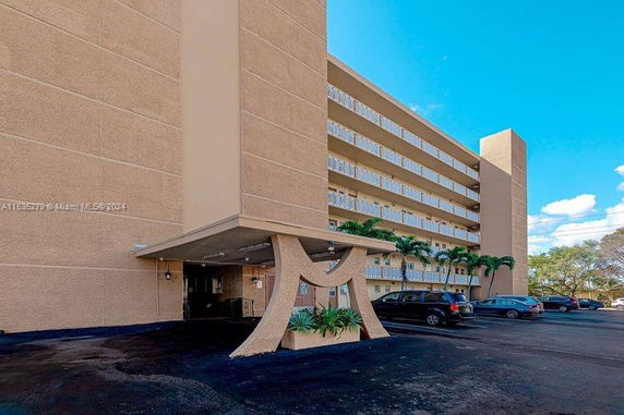 Front view of a multi-story building with a distinctive entrance design.