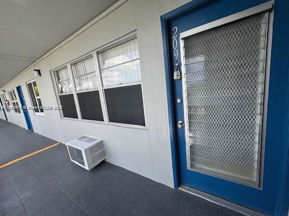 Front view of an apartment building corridor with a blue door.