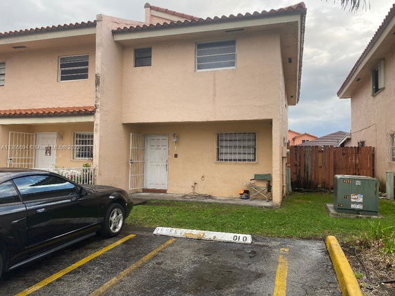 Front view of a two-story house with a reserved parking spot.