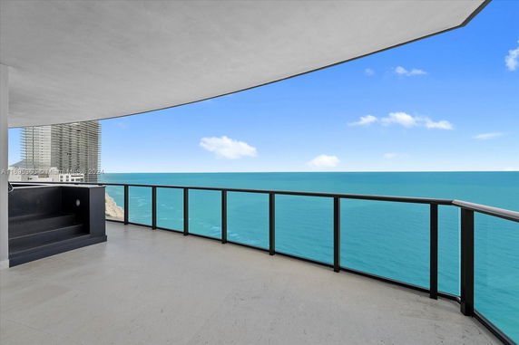 View from a building balcony overlooking the ocean.
