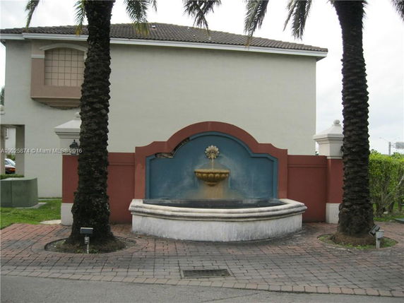 Front view of a building with a decorative fountain.
