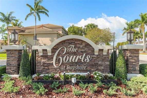 Front view of a building with a sign reading 'The Courts at Bayshore'.