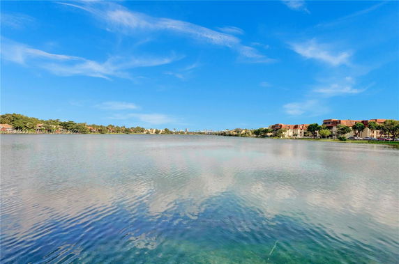Panoramic view of a lake with buildings on the shoreline.