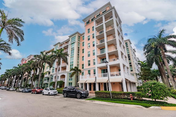 Front view of a multi-story residential building with balconies.