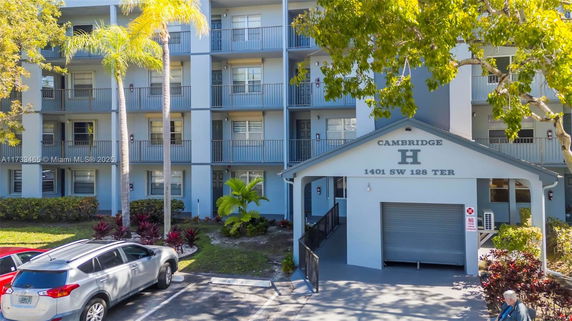 Front view of a multi-story residential building with balconies.