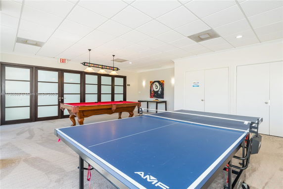Indoor recreational area with a ping pong table and a pool table.