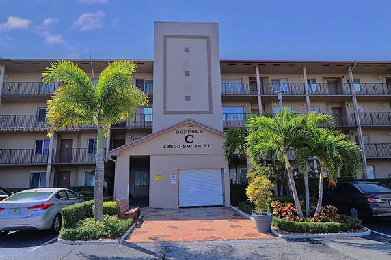 Front view of a multi-story residential building with balconies.