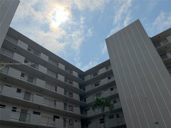 View of a multi-story apartment building with balconies.