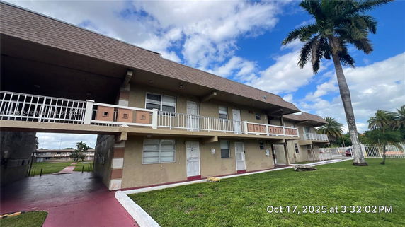 Front view of a two-story apartment building with balconies.