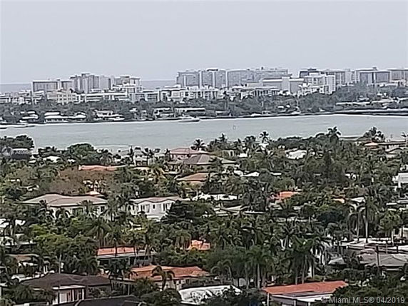 Panoramic view of urban area with water and buildings in the distance.