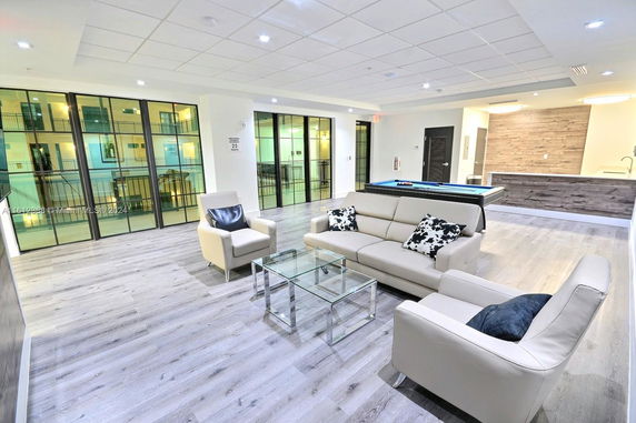 Indoor recreation area with seating and a pool table.