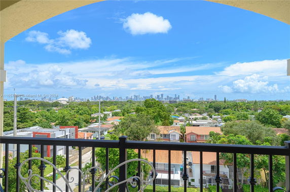 Panoramic view of a city skyline and surrounding residential area from a building.