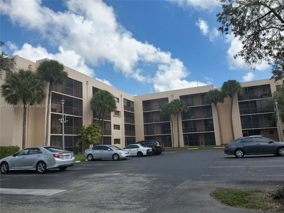 Front view of a multi-story residential building with balconies.
