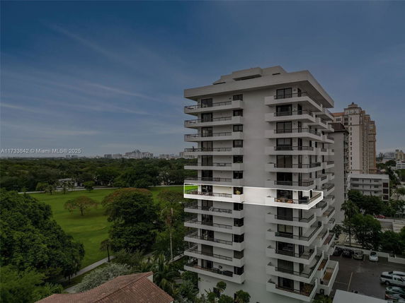 Elevated view of a multi-story apartment building with balconies.