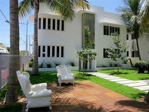 Front view of a modern two-story house with a unique glass block feature.