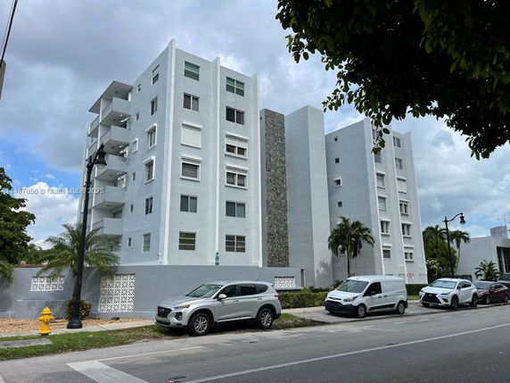 Front view of a multi-story residential building with multiple balconies.