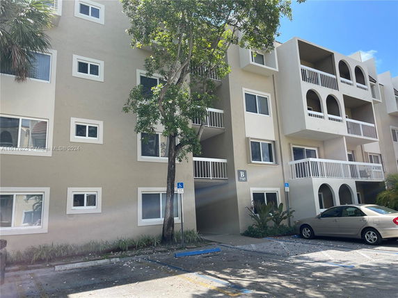 Front view of a multi-story building with balconies.