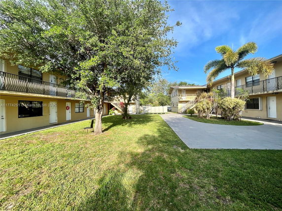 Front view of a two-story apartment building with balconies.