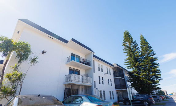 Front view of a multi-story residential building with balconies.