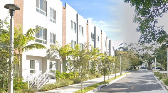 Front view of a three-story townhouse complex.