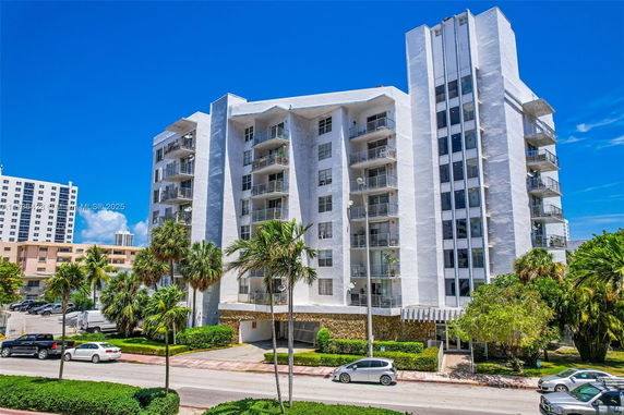 Front view of a multi-story residential building with balconies.