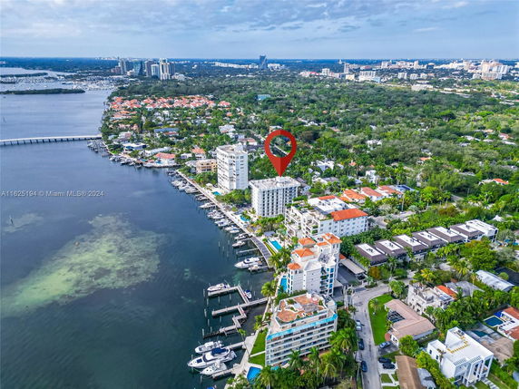 Aerial view of a coastal area with buildings and a marina.