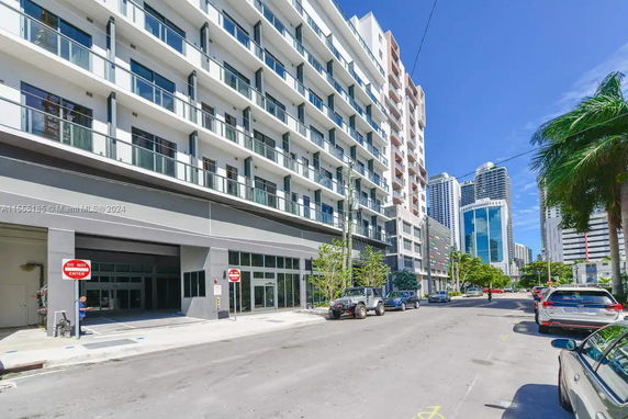 Front view of a multi-story residential building with balconies.