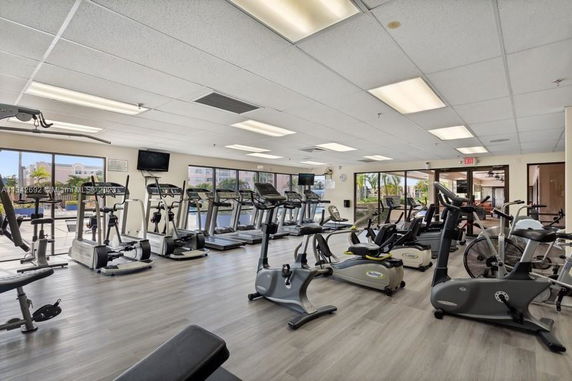 Room with exercise equipment like treadmills and stationary bikes.