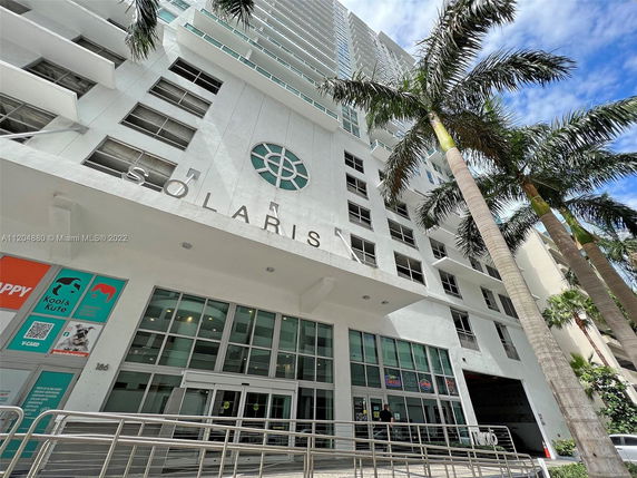 Front view of a multi-story building with a large entrance and the name 'SOLARIS' displayed on the facade.