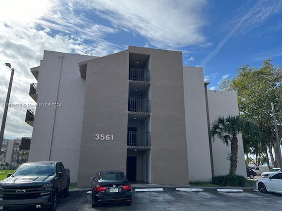 Front view of a multi-story building with balconies.