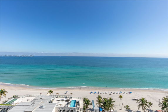 Panoramic view of the ocean and beachfront from a building.