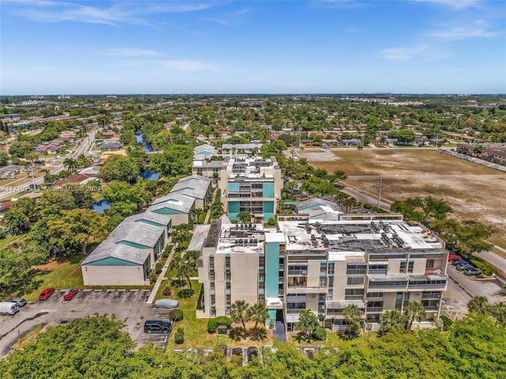 Aerial view of residential buildings and surrounding neighborhood.