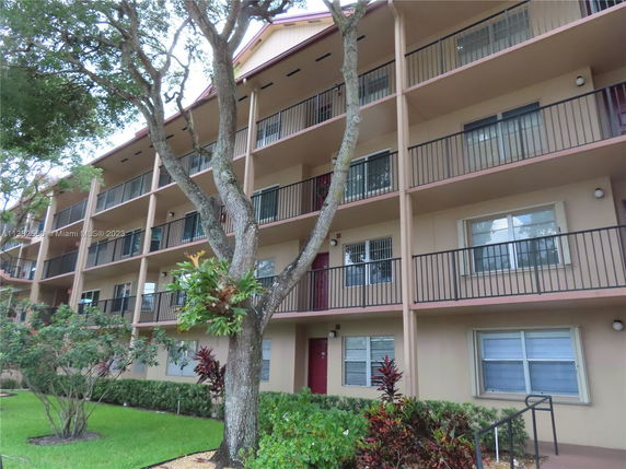 Front view of a multi-story residential building with balconies.