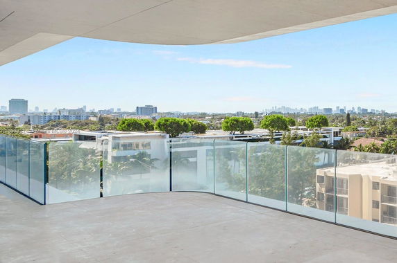 Panoramic view from a building, overlooking cityscape with distant skyscrapers.