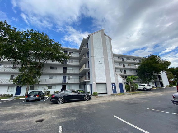 Front view of a multi-story residential building with balconies.