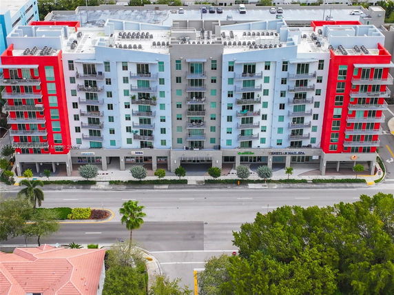 Front view of a multi-story apartment building with colorful exterior.