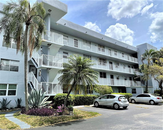 Front view of a multi-story apartment building with balconies.