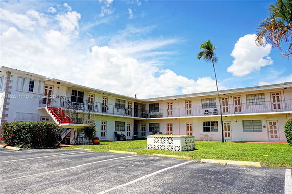 Front view of a two-story residential building with exterior staircases.