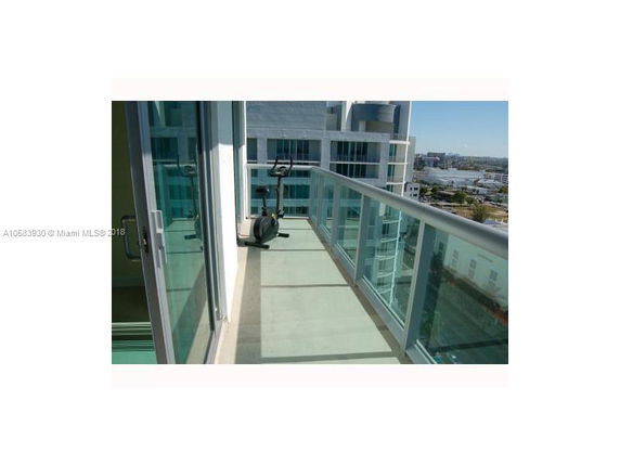 View from a balcony overlooking surrounding city buildings.