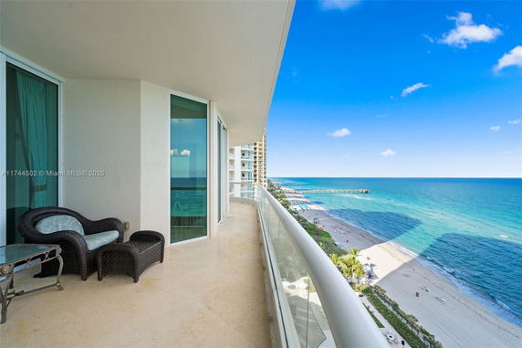 Balcony view overlooking the ocean and beach.