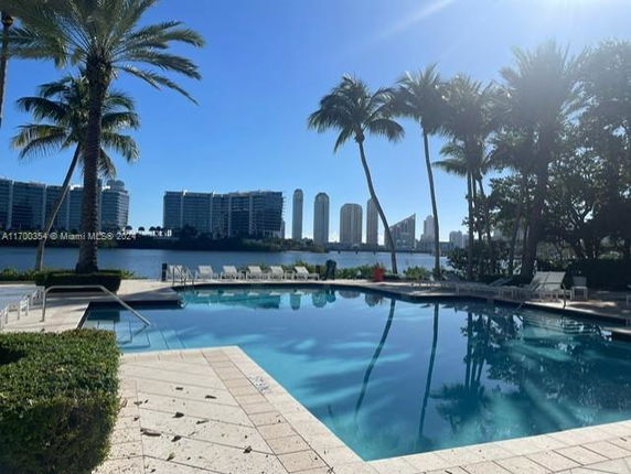 Outdoor swimming pool with high-rise buildings in the background.