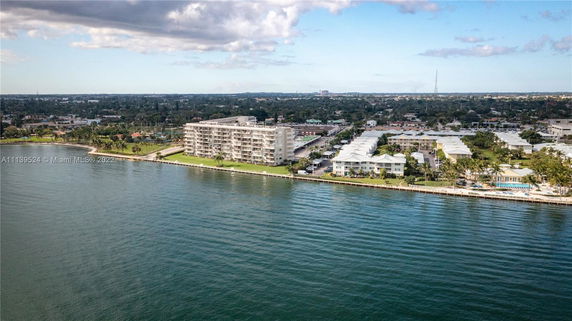 Aerial view of waterfront buildings next to a body of water.