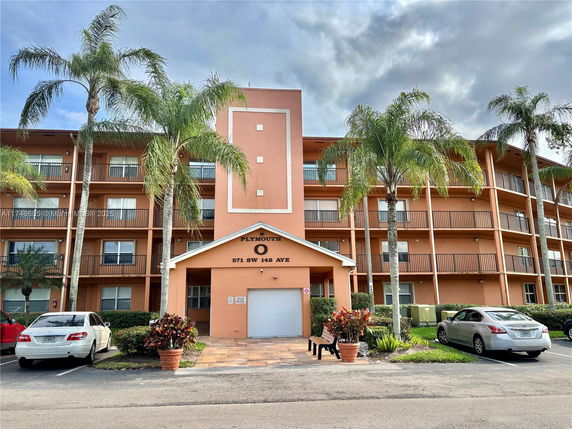 Front view of a multi-story residential building with balconies