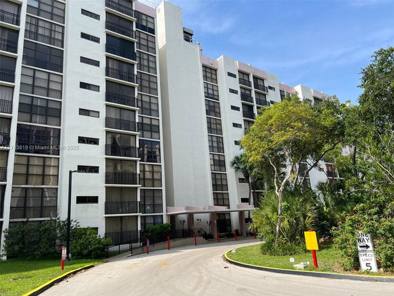Front view of a multi-story residential building with balconies.