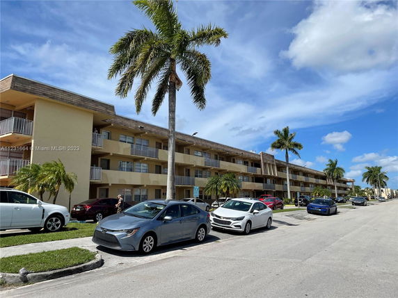 Front view of a multi-story residential building with balconies.