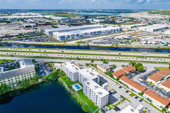Panoramic view of a city area with warehouses, roads, and residential buildings.