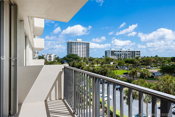 View from a balcony showcasing surrounding buildings and greenery.